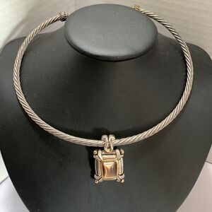 Silvertone choker with pendant which includes tiny detail of goldtone.